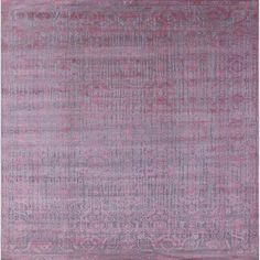 an area rug with pink and grey colors