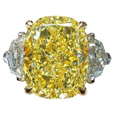 Amongst Cushion Cut Yellow Diamonds, Elongated Pillow Shapes are the most coveted and desired outlines They look larger than their weight suggests, and they look like true gems.. Our vibrant and pure GIA Certified 4.02 Carat Cushion Cut Fancy Yellow Diamond Three Stone Ring features a beautifully rectangular pillow shaped Cushion Cut Yellow Diamond. The warm sunny Yellow tone of the center stone is accentuated and emphasized by two High-Colorless GIA Certified Epaulette Cut Diamond side stone weighing a total of 0.71 carats. GIA Grades are D-VVS1 & E-VS1. Both without fluorescence. Center Cushion Cut GIA Graded as: Fancy Yellow SI1, no fluorescence. Set in our Handmade, 950PLAT/18KT, 3 Stone ring. Size 6 Sizing / Engraving available on request Canary Diamond Ring, Canary Yellow Diamonds, Radiant Diamond Rings, Radiant Cut Diamond Ring, Canary Diamond, Cushion Diamond Ring, Yellow Diamonds Engagement, Yellow Diamond Engagement Ring, Cushion Cut Diamond Ring