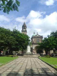 a large building with a clock tower in the middle of it's front yard