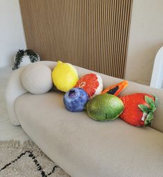 an assortment of fruit sitting on top of a couch