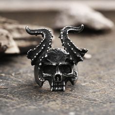 Weird and exaggerated, this is the first impression this ring brings to people. Skeletons with... Gothic Horned Jewelry For Halloween, Gothic Horned Metal Jewelry, Horned Gothic Metal Jewelry, Gothic Metal Skull Ring, Black Symbolic Skull Ring For Halloween, Symbolic Black Skull Ring For Halloween, Unique Black Metal Skull Ring, Unique Black Skull Ring For Halloween, Punk Metal Skull Ring For Halloween