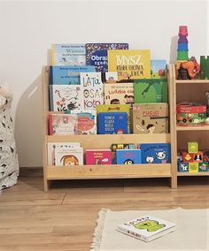 two wooden bookshelves filled with children's books on top of hard wood floors