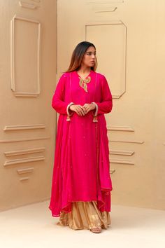 This bright pink and gold wide leg shalwar kameez features a stunning shocking pink chiffon fabric with intricate mukesh chhan detailing all over the shirt and dupatta. With tikka work leaves adorning the neck, this ensemble exudes elegance and sophistication, perfect for any special occasion. 3-Piece Suit Shocking Pink, Pink Chiffon, Shalwar Kameez, 3 Piece Suits, Chiffon Fabric, Wedding Men, Bright Pink, Winter Women, Pink And Gold