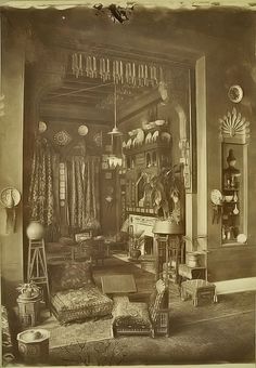 an old photo of a living room filled with furniture