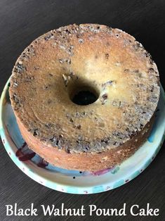 a round cake sitting on top of a plate with the words black walnut pound cake