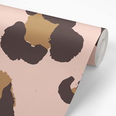 a pink and brown floral wallpaper with black spots on the top part of it