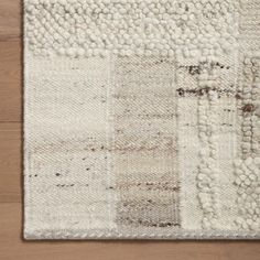 an area rug with white and brown colors