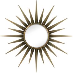 a mirror that is sitting on top of a white wall with a sunburst design