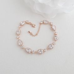 Bracelet for Wedding Day in Rose Gold and Pear-Shaped Cubic Zirconia You will love this beautiful and elegant bridal bracelet made of pear-shaped or teardrop cubic zirconia and plated in rose gold. The bracelet is great to wear on your wedding day; it offers plenty of sparkly. The bracelet can be worn long after the wedding on special occasions and will be a wonderful gift to your loved ones. The pear-shaped rose gold bridal bracelet can also be purchased in silver and yellow gold. The bracelet Simple Bridal Jewelry Sets, Silver Wedding Bracelet, Gold Bracelet Wedding, Simple Bridal Jewelry, Yellow Gold Drop Earrings, Teardrop Jewelry, Bridal Earrings Drop, Gold Bridal Earrings, Gold Jewelry Sets