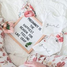 a person laying on top of a bed holding a book