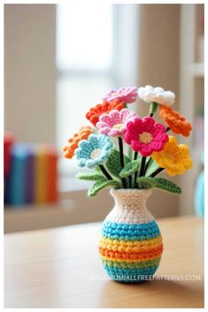 a crocheted vase with colorful flowers in it