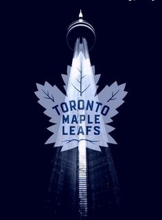 the toronto maple leafs sign is lit up against a dark sky with trees and leaves