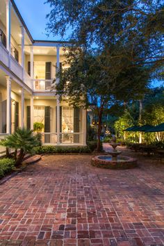 an outdoor courtyard with brick pavers and trees