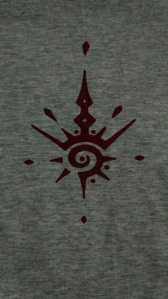 an image of a red and black design on a grey shirt with the eye in it