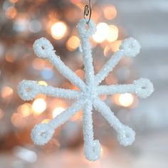 a snowflake ornament hanging from a christmas tree