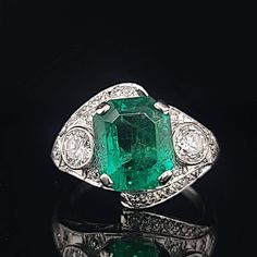 Gorgeous Vintage Diamond & Emerald in Platinum ring circ 1920's center set natural Colombia emerald weight 4.43ct size 11.1x9.3mm GIA cert. Has a nice rich green color ,brilliant clean very lively stones. Side Set two Natural old mine cut Diamonds Weight 0.50ct. Size 4mm SI1 -G lively brilliant, clean white bright stones. Side set small diamonds weight 0.25ct. Ring size 7.5 Resizable This tremendous old vintage ring is in a very good condition. Retail value $18,500 net. Appraisal available Art Deco Emerald Ring With Diamond, Art Deco Emerald Ring In Platinum, Art Deco Platinum Emerald Ring, Art Deco Oval Emerald Ring With Brilliant Cut, Art Deco Emerald Ring With 17 Jewels, Art Deco Green Diamond Ring Hallmarked, Art Deco Green Jewelry With Brilliant Cut, Gia Certified Oval Emerald Ring In Art Deco Style, Art Deco Emerald Ring With Round Cut In Platinum