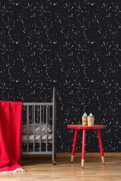 a baby's room with stars on the wall and a crib next to it