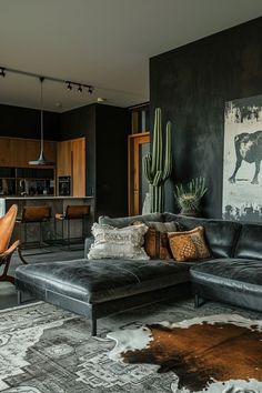 a living room filled with furniture and a cow print on the wall above it's couch