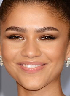 an image of a woman smiling at the camera with her hair in a bunt