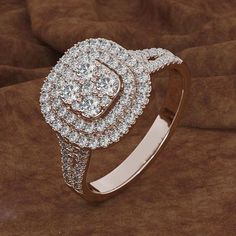 a diamond ring on top of a brown cloth