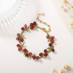 This Cranberry Agate Bracelet is the perfect accessory for the luxury-minded. From the stunning cranberry colour to the glossy agate stone, every element is carefully crafted for a sophisticated and exclusive look. Define your style with this timeless piece. DETAILS Plating: 18K Gold Materials: 18K Gold on Brass, Natural Stone Measurements: Length: 6.69"(17cm) + Extender: 2.76"(7.0cm) Weight: 15.43g There will be a little difference among different production batches of products due to the varia Elegant Red Agate Beaded Bracelets, Elegant Red Agate Bracelets, Adjustable Ruby Bracelets Gift, Elegant Agate Beaded Bracelets For Gift, Handmade Ruby Bracelets As Gifts, Handmade Adjustable Ruby Bracelet, Handmade Adjustable Ruby Bracelets, Ruby Bracelets As A Gift, Elegant Handmade Red Charm Bracelet