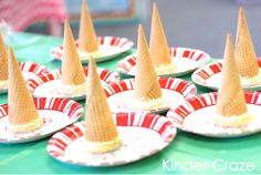 several plates with cones on them sitting on a table