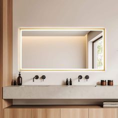 a bathroom with two sinks and a large mirror over it's counter top that is illuminated