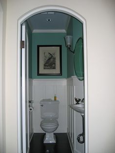 an open doorway leading to a bathroom with a toilet and sink