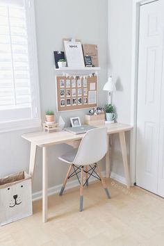 a home office with a desk, chair and storage bins on the wall behind it