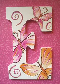 the letter c is decorated with butterflies and swirls on white paper, which has pink background