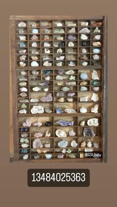 a wooden box filled with lots of different types of rocks and stones on it's sides