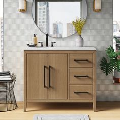 a bathroom vanity with a round mirror above it and a rug on the floor next to it