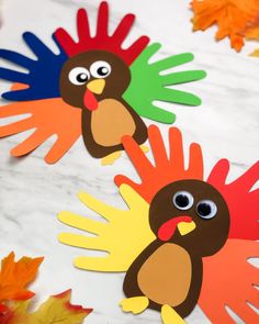 paper turkeys are on the table with fall leaves