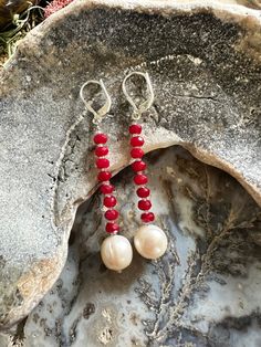 Long length 2-1/4" freshwater pearl drop earrings with faceted red jade and sterling silver leverbacks.  The pearls are 10mm in size.  Pearls are June's birthstone. It is said:  "The inner glow (orient) of pearls is thought to tap inner wisdom and nurture love. Pearls are also believed to signify innocence and faith. Practitioners use pearls to enhance personal integrity, bring truth forward, grow sincerity, inhibit immodest behavior and advance in wisdom."