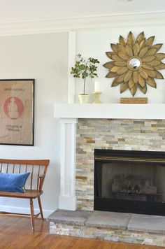 a living room with a fire place and a chair in front of the fireplace that has a sunflower on it