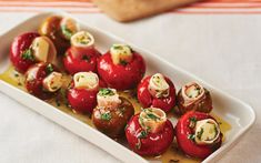 small appetizers are arranged on a white platter