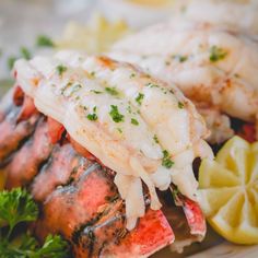 lobster with lemon wedges and parsley on the side