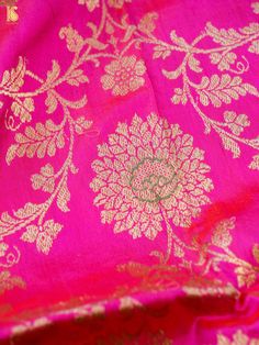 pink and gold brocaded banaram saree with floral design on the border