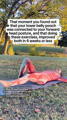 a man laying on top of a yoga mat in the middle of a field with trees