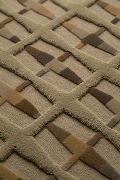 a close up view of an area rug with different colored squares and lines on it