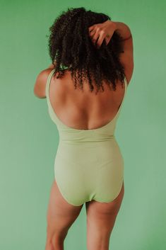 We love a textured one piece! Our custom scrunch one piece is sewn in the dreamiest textured fabric in citron green. Designed by the Pink Desert Design Team. A simple silhouette that is easy to wear, comfy, and super trendy, not to mention flattering! Pink Desert brand Scrunch fabric Scoop neck Supportive for busts A-DD Full bottom coverage Nursing friendly Floating shelf bra with soft, removable cups Fully lined front and back Self: 92% polyester, 8% spandex Lining: 92% polyester, 8% spandex Pr Fitted Green Ribbed Swimwear, Green Ribbed Swimwear For The Beach, Green Ribbed Swimwear For Beach, Green Textured Swimwear For Summer, Textured Green Swimwear For Summer, Green Textured Fitted Swimwear, Textured Green Swimwear For Poolside, Fitted Textured Green Swimwear, Green Stretch Summer Bodysuit