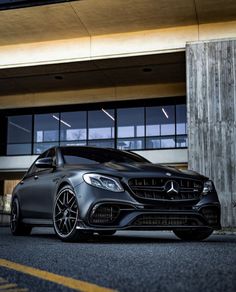 a black car parked in front of a building