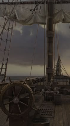 the deck of a large ship at dusk with clouds in the sky and water behind it