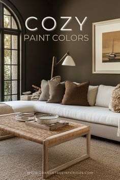 a living room with brown walls and white furniture