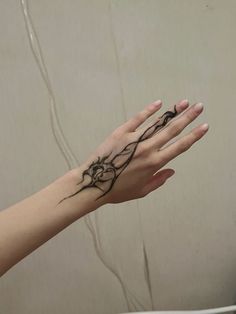 a woman's hand with a tattoo on it