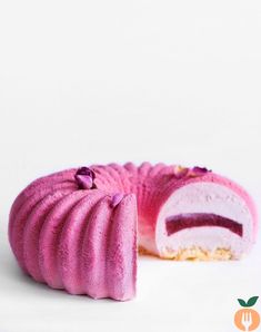 there is a pink cake that has been cut in half