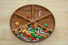 a wooden plate with candy and candies on it