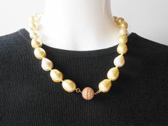 "Gorgeous yellow pearl necklace. What a beautiful necklace!. This is a single strand of yellow pearl beads that are hand tied. This necklace has a round ball with a goldtone settings rhinestone trim. This ball is beautiful worn in the center front or worn on the side. You will love this necklace.Beautiful daytime pearls and a lovely pearl gift for her. MATERIAL: Pearl beads, rhinestones CONDITION: It is in very good condition SIZE: It measures 18.5\" in length COLOR: Yellow" Pearl Gifts, Pearls Jewelry, Yellow Pearl, Rhinestone Trim, Beautiful Necklace, Wedding Necklace, Pearl Beads, Beautiful Necklaces, Pearl Necklace