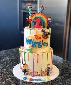 the wiggles birthday cake is decorated with rainbow icing and sprinkles