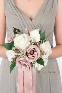 a bridesmaid holding a bouquet of flowers in her hands